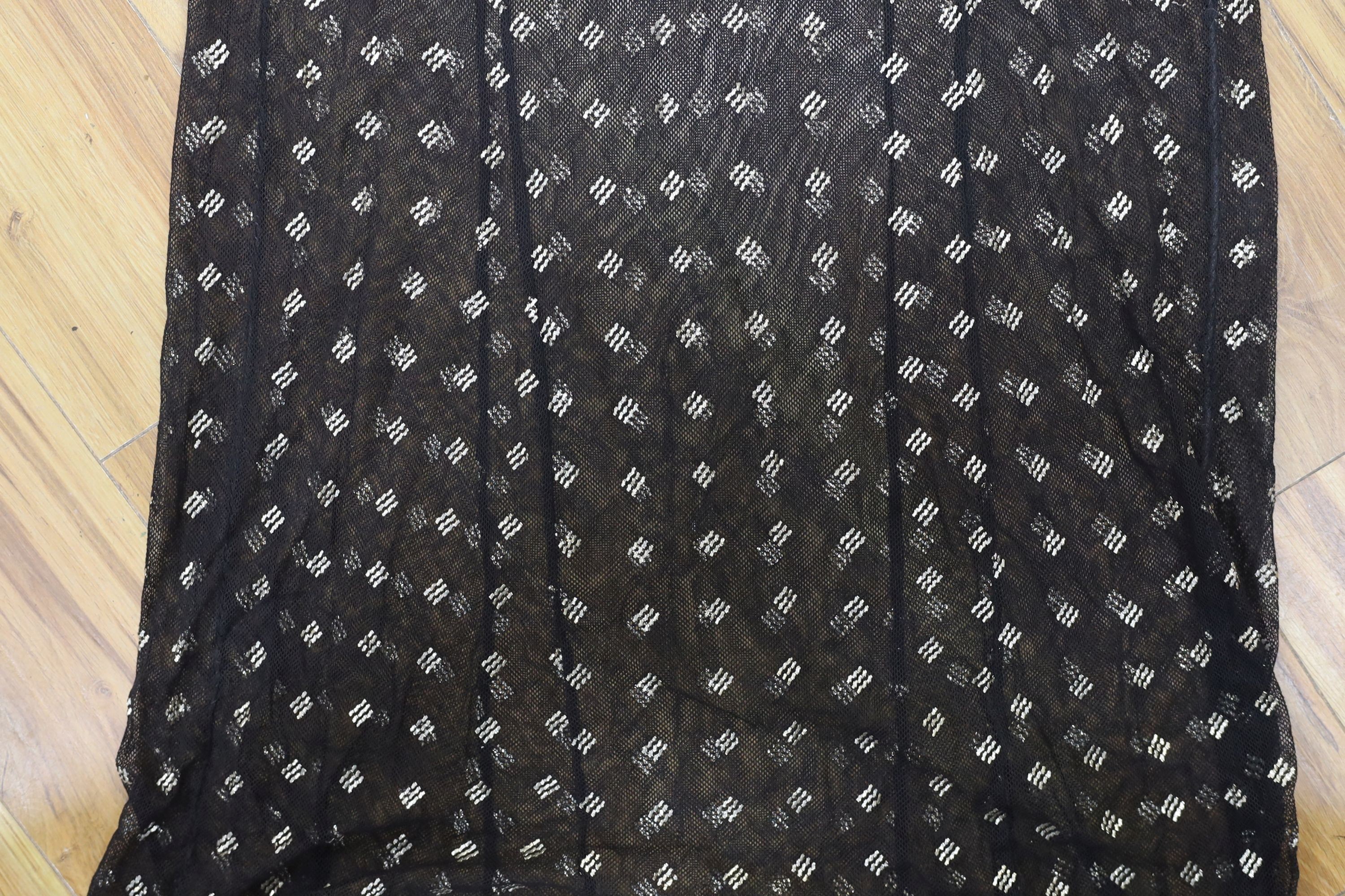 A dress made from a metal and black net Egyptian shawl; a similar shawl and a piece of shawl